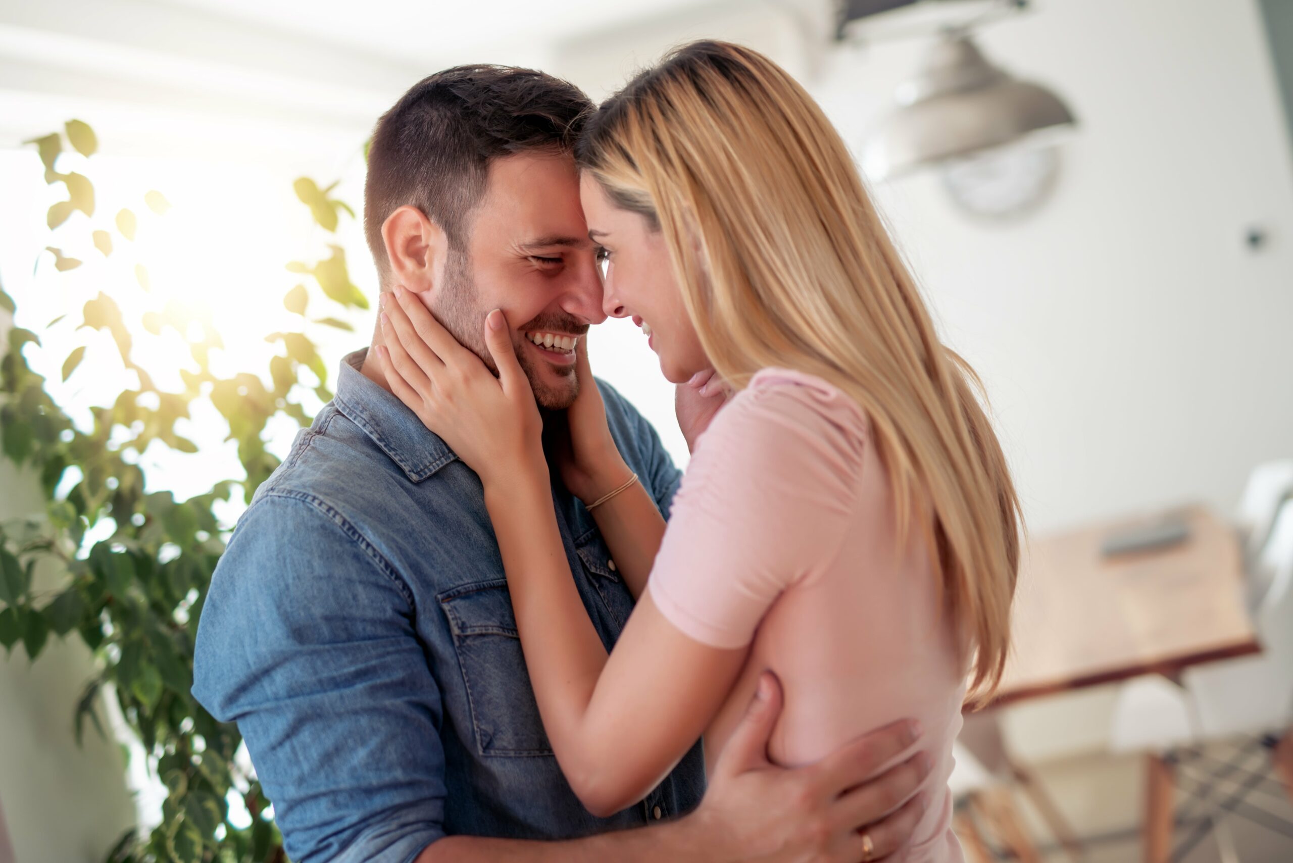 men and woman hugging intimately 