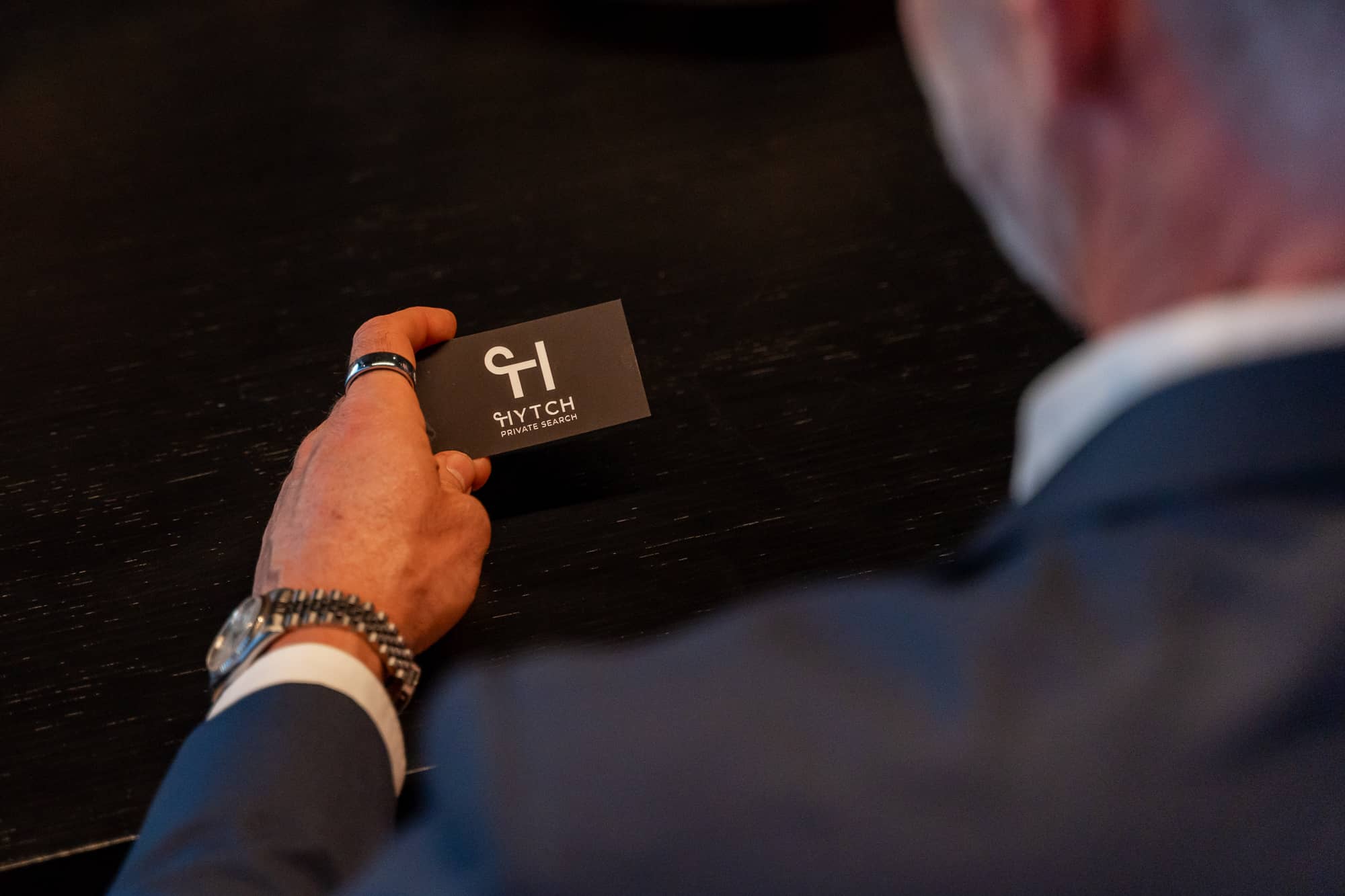 man holding HYTCH business card